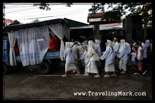 Buddhist Monks Inside a Truck with the Deceased, Family Members in Full White Behind