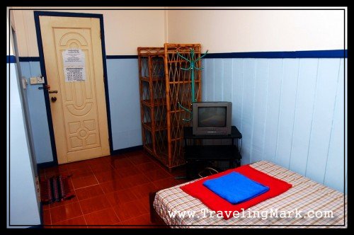 Entrance to the Room with View of Clothes Rack and a TV Set