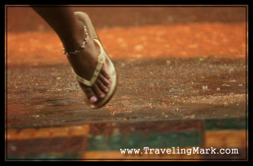 Young Cambodian Girl Rushes Under The Roof to Avoid Getting too Wet from the Rain