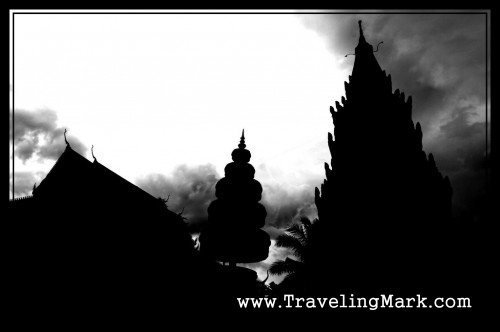 Silhouettes of Wat Preah Prom Rath Against Cloudy Skies