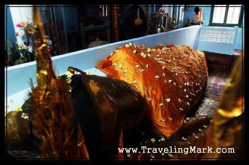 Photo of Reclining Buddha from Opposite Angle Shows Temple Keeper who Took me to the Statue in the Background