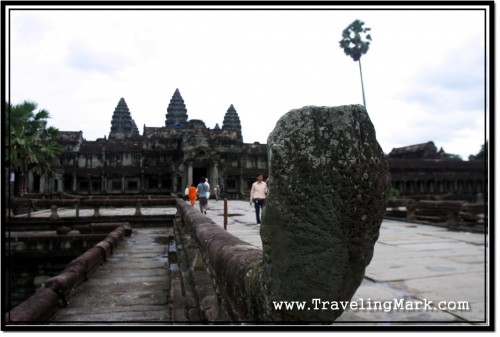 Photo: Damaged Naga at the End of Balustrade Lining Up the Causeway to Angkor Wat