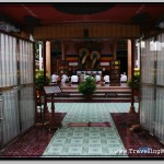 Buddhists Praying at the Wat Preah Prom Rath Temple Seen Through the Gate