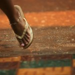 Young Cambodian Girl Rushes Under The Roof to Avoid Getting too Wet from the Rain