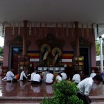 Devoted Buddhists Praying Together on the Steps of the Wat Preah Prom Rath Temple