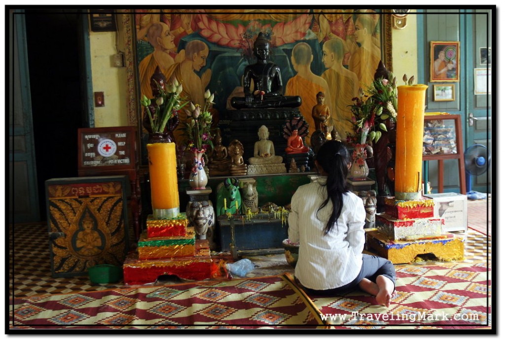 Photo: Girl Praying Before Buddha Statue at Wat Damnak Vihara