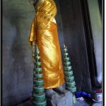 Photo: Golden Fabric Clad Statue of Buddha Misses Head and Arms