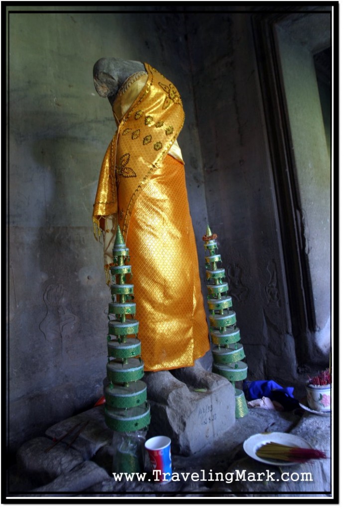 Photo: Golden Fabric Clad Statue of Buddha Misses Head and Arms