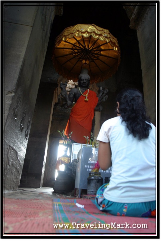 Photo: Cambodian Woman Prays Before the Depiction of Vishna, Remnant of Hinduism