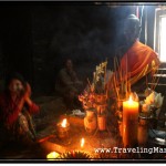 Photo: Cambodian Woman Praying Before the Statue of Buddha at Bayon Temple