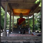 Photo: Sandstone Statue of Buddha at Preah Ngoc Attended to by Two Cambodian Nuns