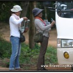 Photo: Touts at Angkor Wat Selling Bootleg Books to Tourists on a Tour Bus