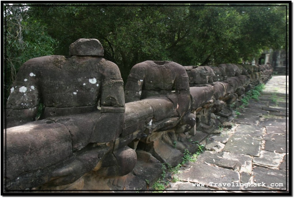 Photo: Headless Asuras Carrying a Body of a Naga Serpent Stand Defaced by Looting Cambodians