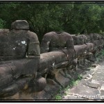 Photo: Headless Asuras Carrying a Body of a Naga Serpent Stand Defaced by Looting Cambodians