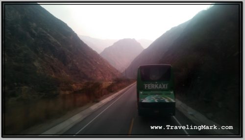 Photo: Another Bus on Road Between Steep Hills