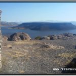 Photo: Sillustani Chullpa in Front of Umayo Lake with Flat Top Island in the Middle