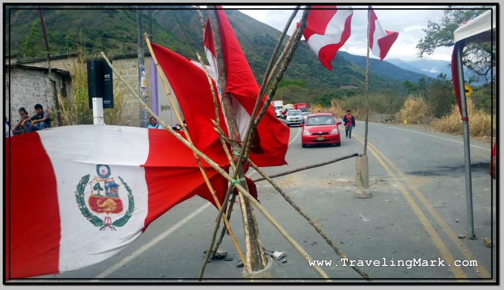 Photo: Line of Cars Stuck at Road Block as Hostile Locals Watch