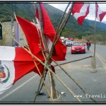 Photo: Line of Cars Stuck at Road Block as Hostile Locals Watch